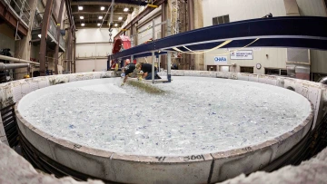 Workers at the University of Arizona's Richard F. Caris Mirror Laboratory place glass in the furnace for the fifth mirror for the Giant Magellan Telescope.