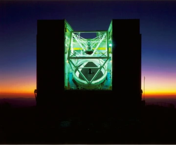 The MMT's single mirror at night The six separate mirrors were replaced by a single mirror, about 21 feet in diameter, which was casted at the UA's Richard F. Caris Mirror Lab in 1992. (Photo: Howard Lester/MMTO)