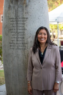 Diane Humetewa stands next to the engraving of her name at the Women's Plaza of Honor