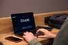 hands typing on a keyboard while the computer screen reads "chatAI"