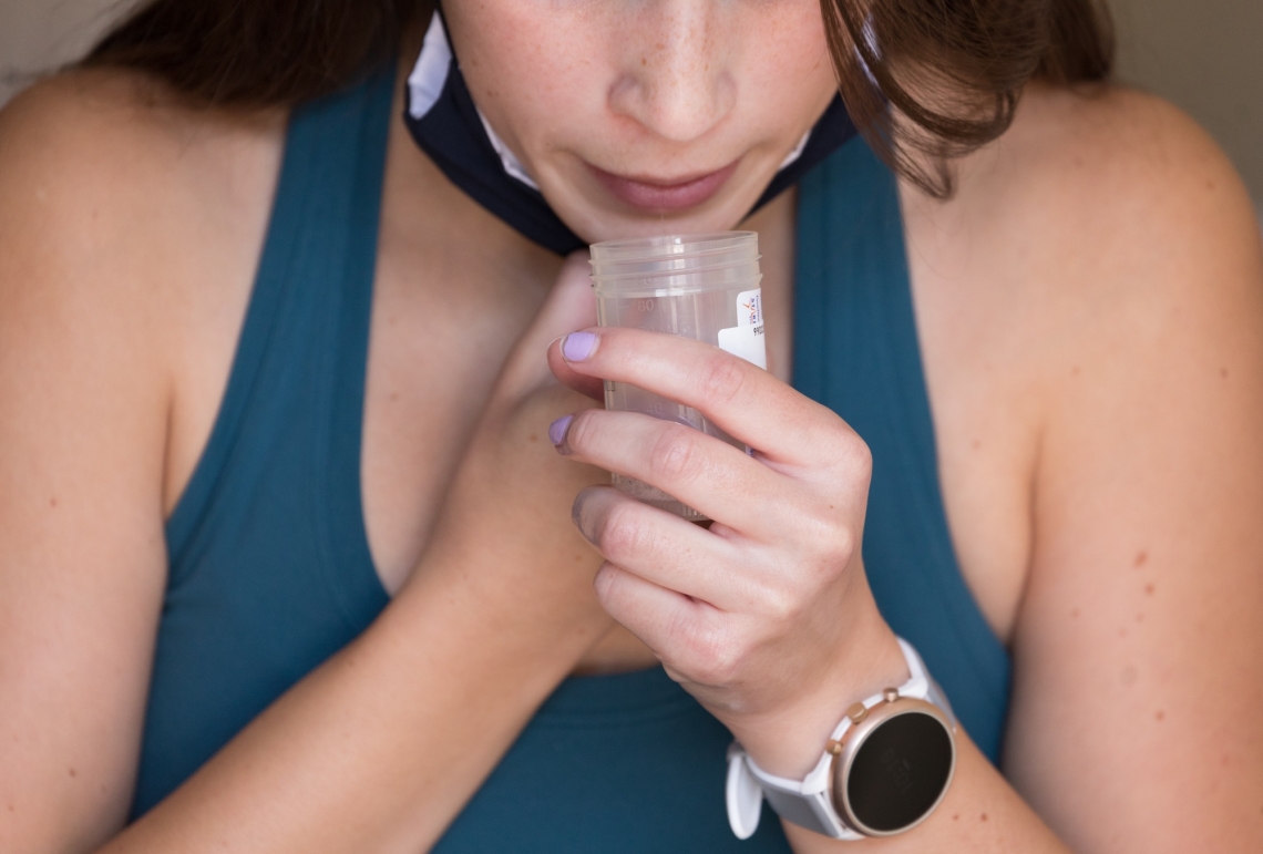 young woman spits in cup
