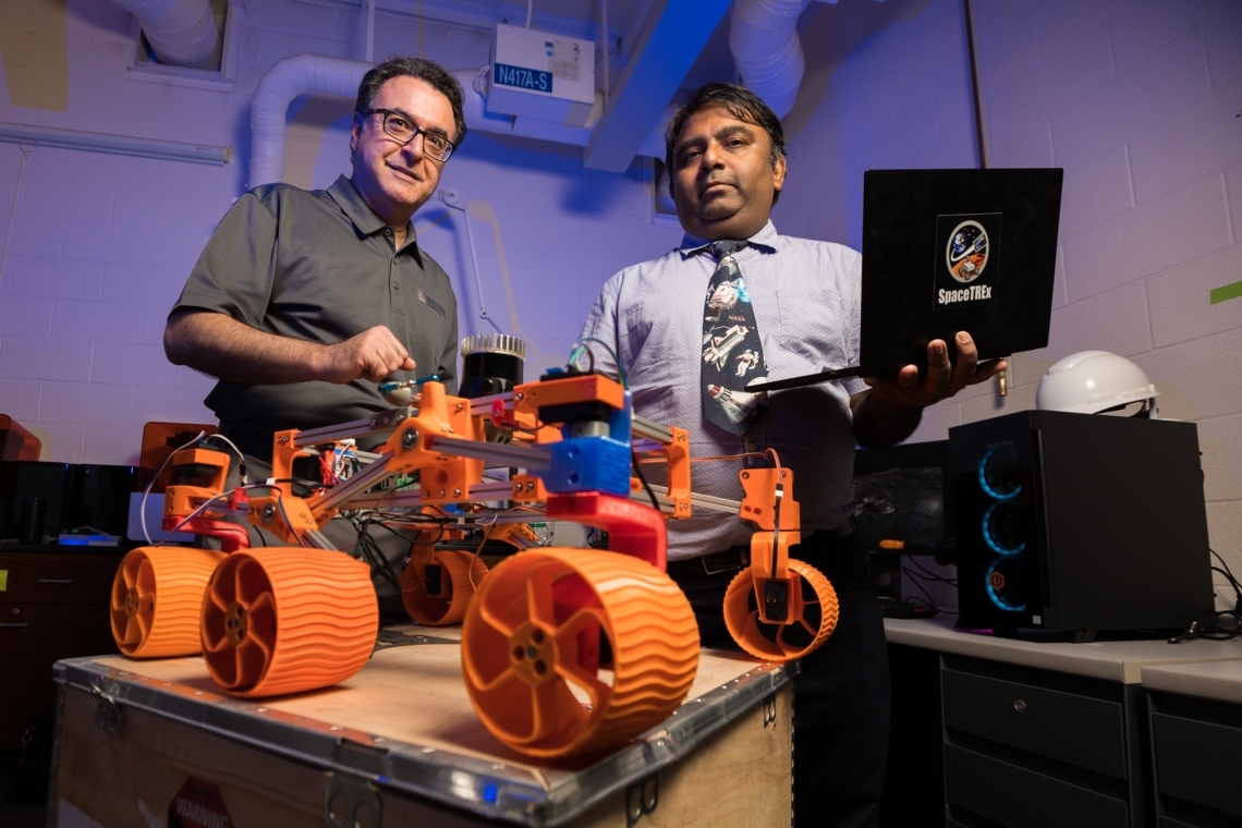 Jekan Thanga and Moe Momayez with a rover prototype