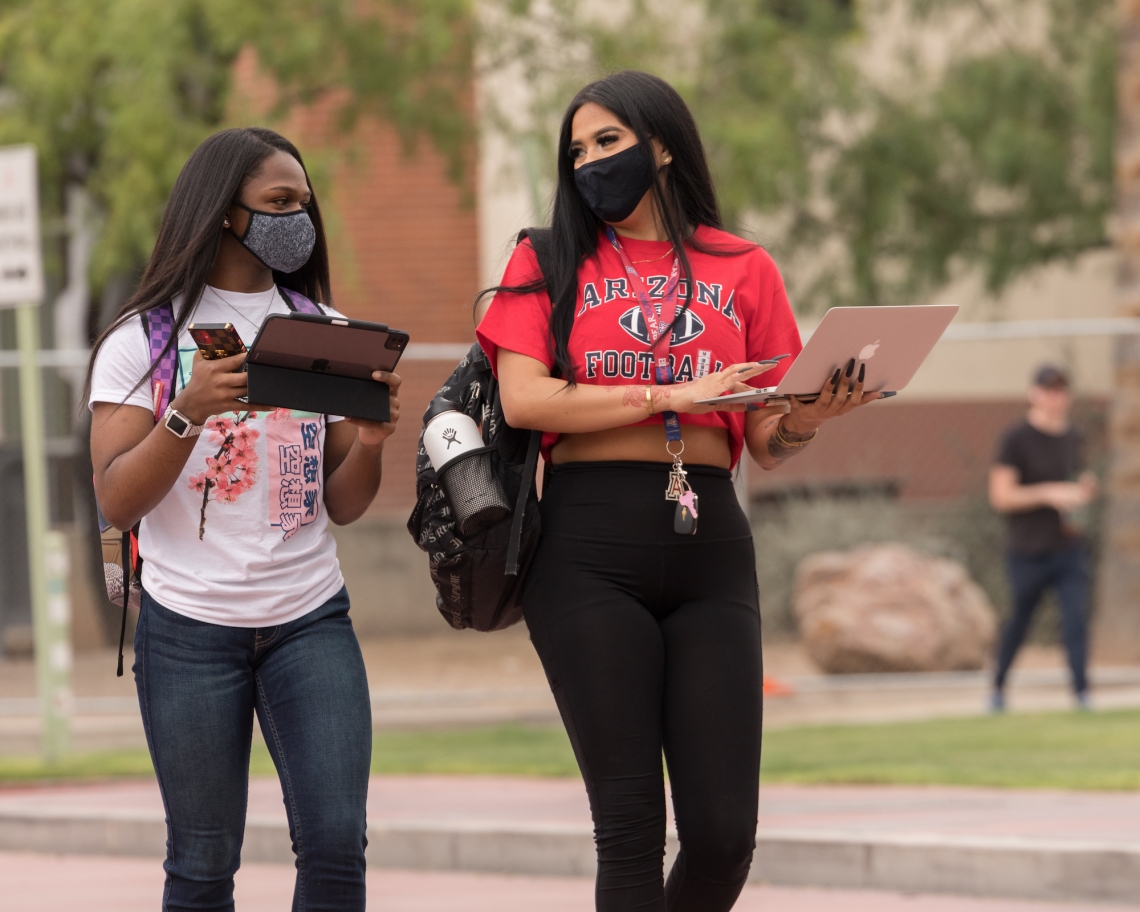 students in face coverings on campus