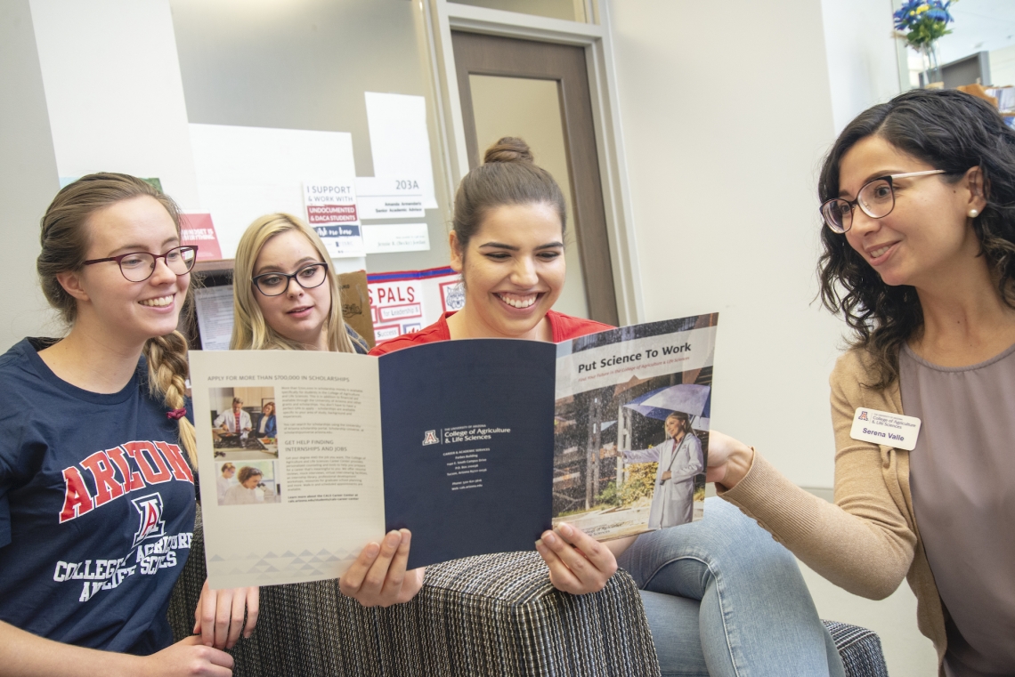 students reading a flyer