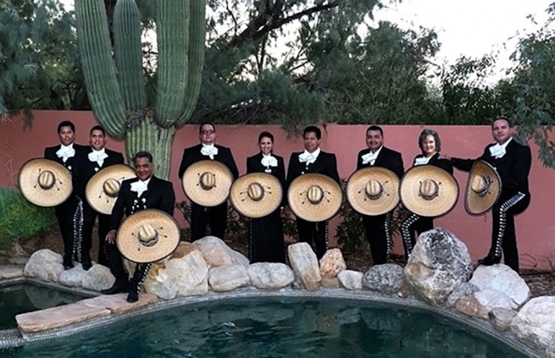 mariachi band posing near a pool