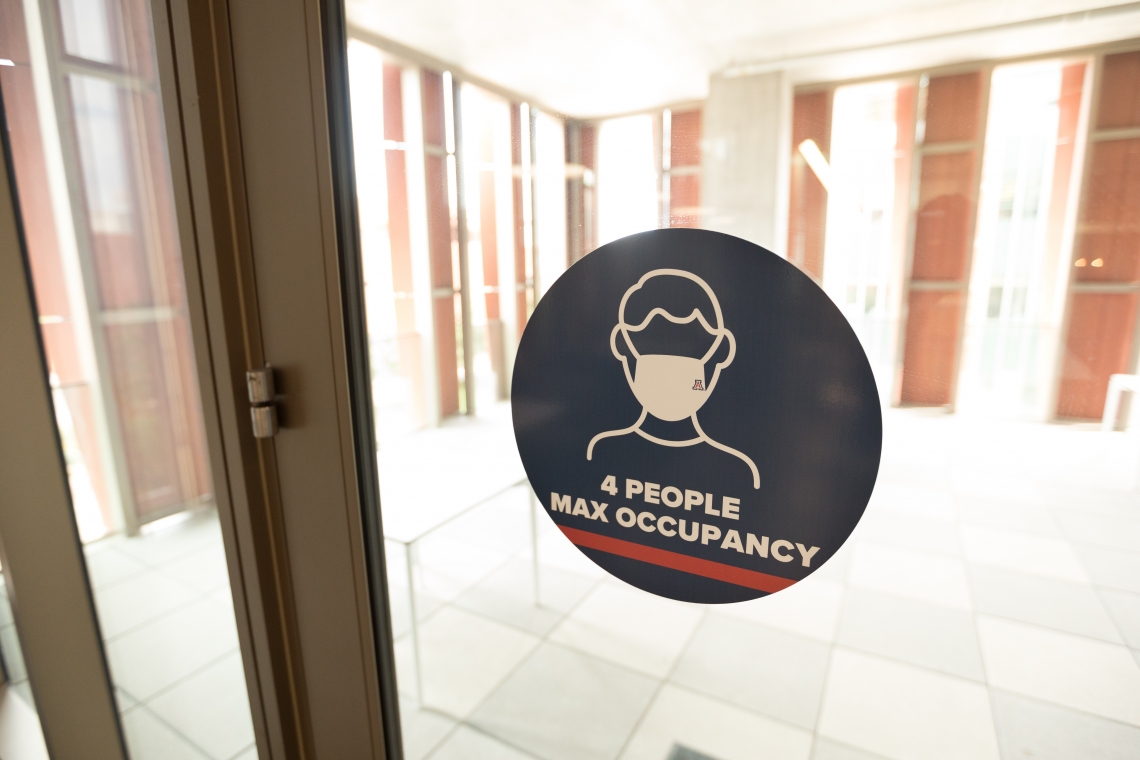 sign on a window that reads "4 people max occupancy"