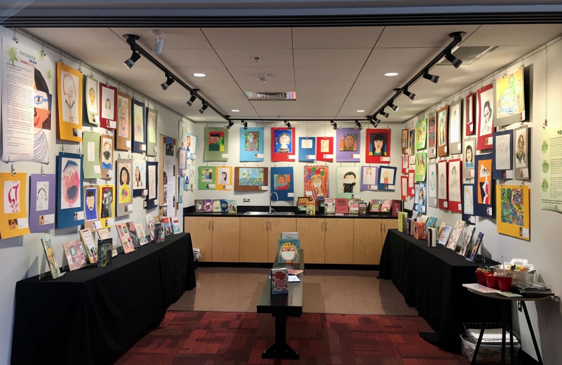 room with children's drawings on the walls