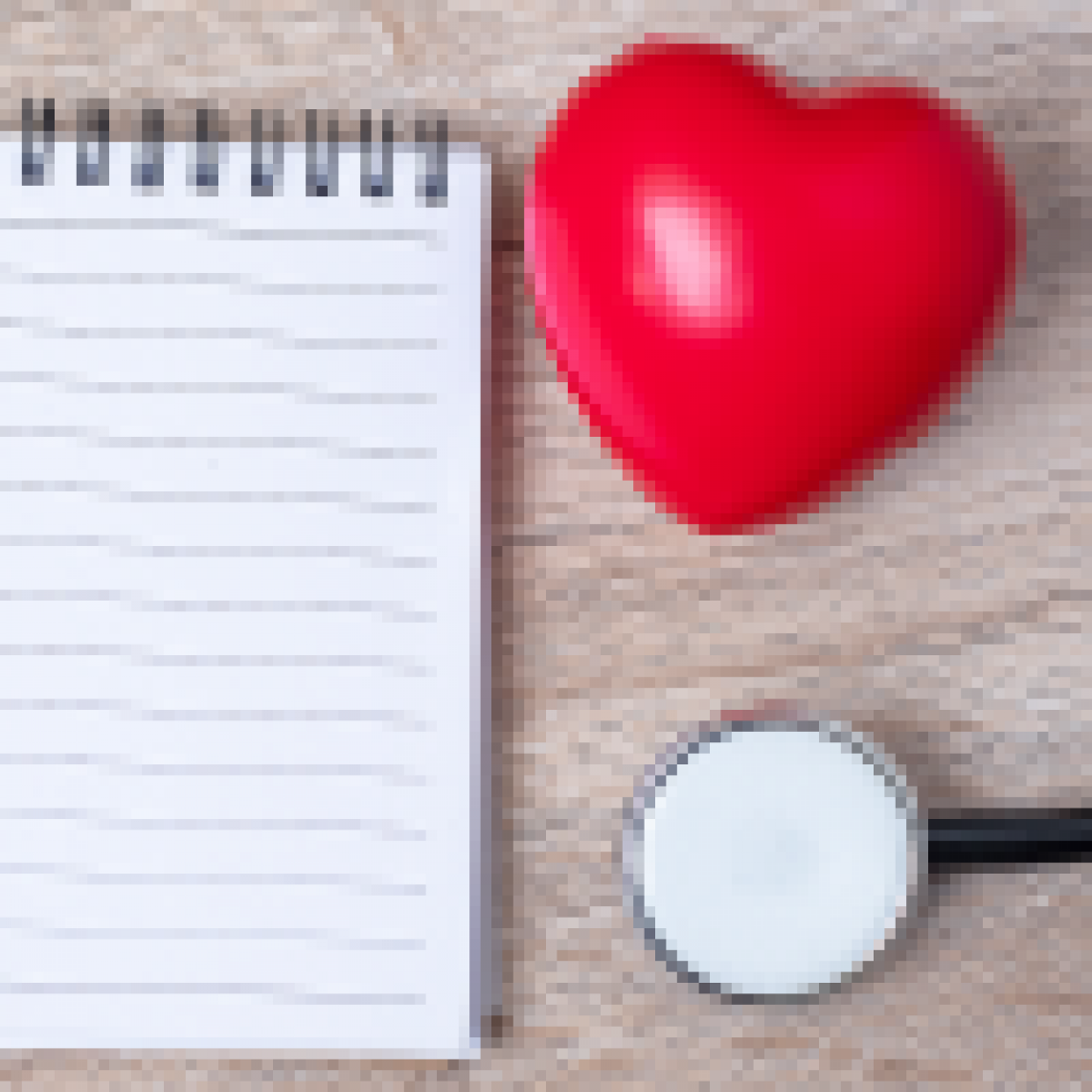 A note pad, stethoscope, and heart-shaped stress ball.