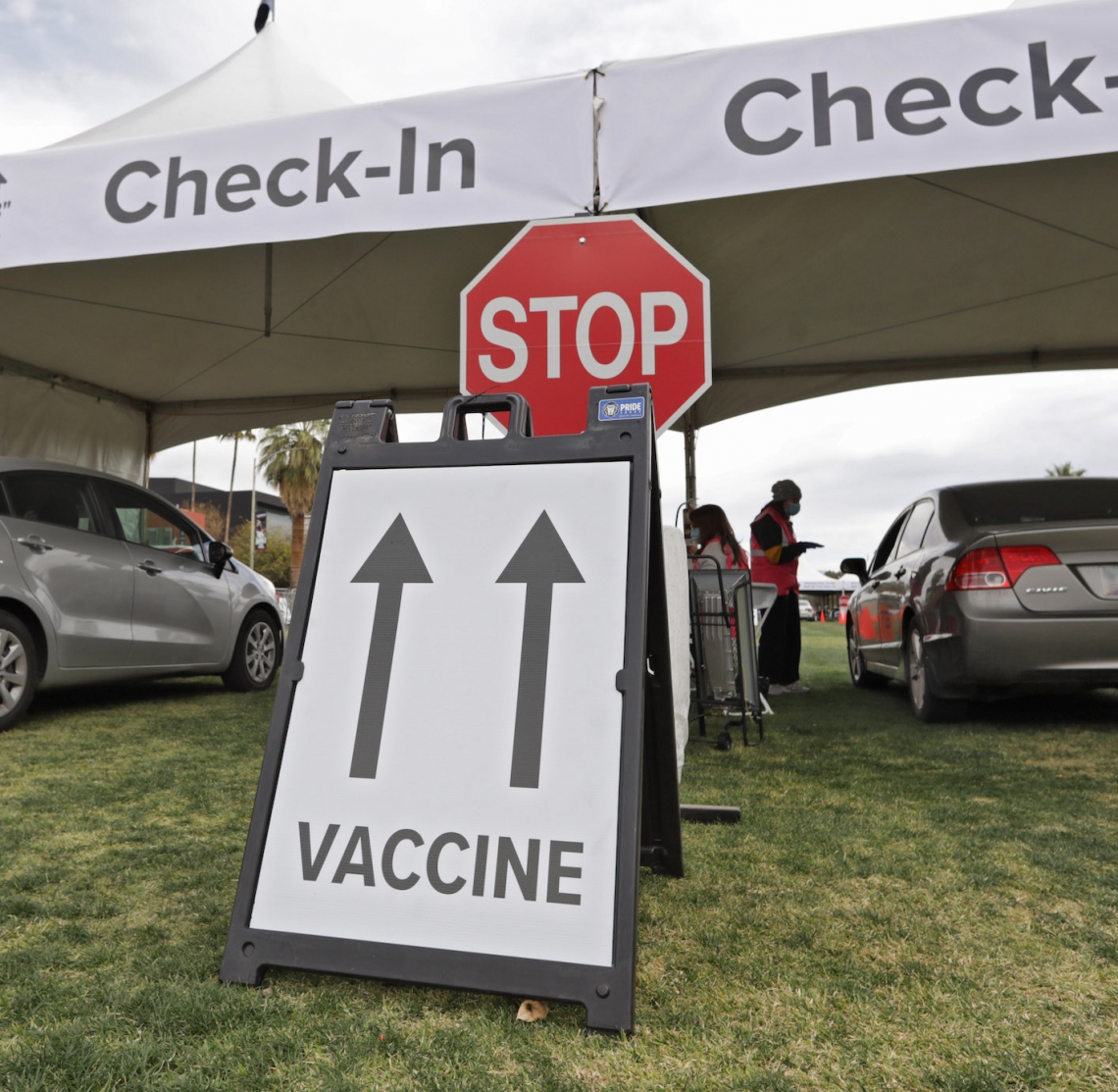 sign with arrows pointing to vaccine distribution site