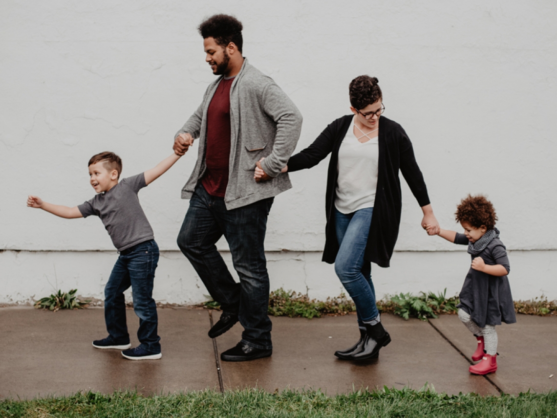 Family walking in the rain.