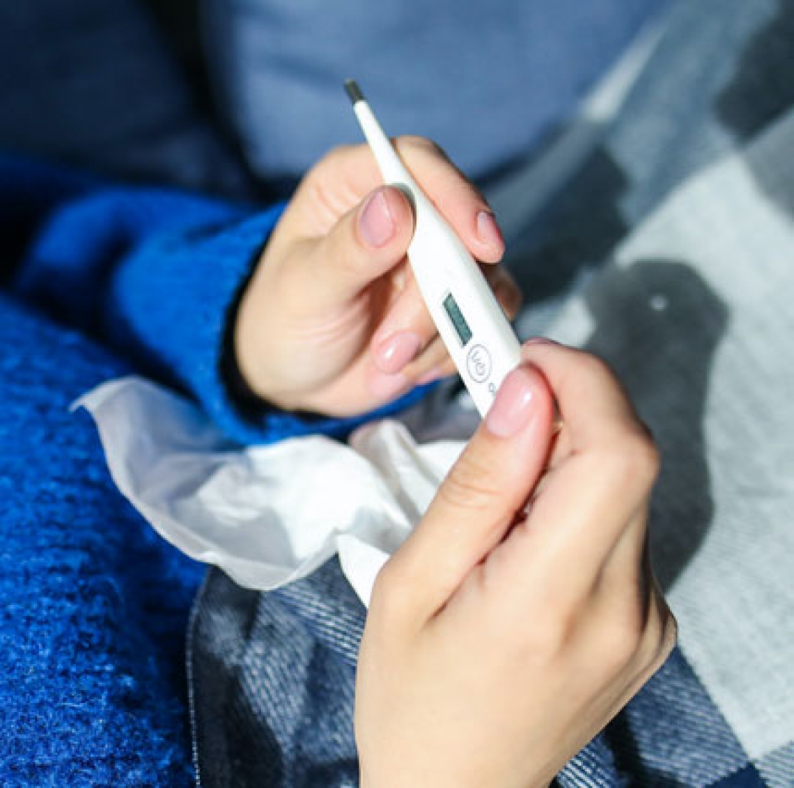 person holding a thermometer