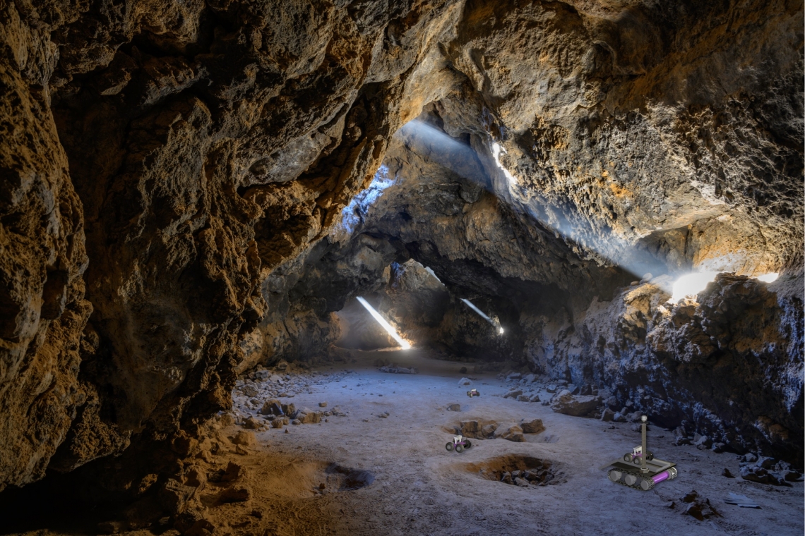 A rover explores a cave with shafts of light coming from above.