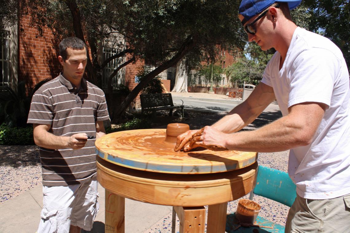 Art student Steve Carcello crafts a pot on a replica of an ancient Greek pottery wheel as biology student Dan Pont measures the wheel's speed. Art student Steve Carcello crafts a pot on a replica of an ancient Greek pottery wheel as biology student Dan Pont measures the wheel's speed.