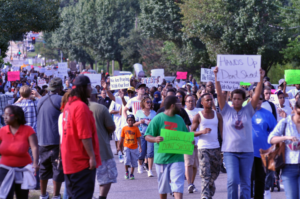 Protesters march in the aftermath of the Aug. 9 shooting death of Michael Brown in Ferguson, Mo. 