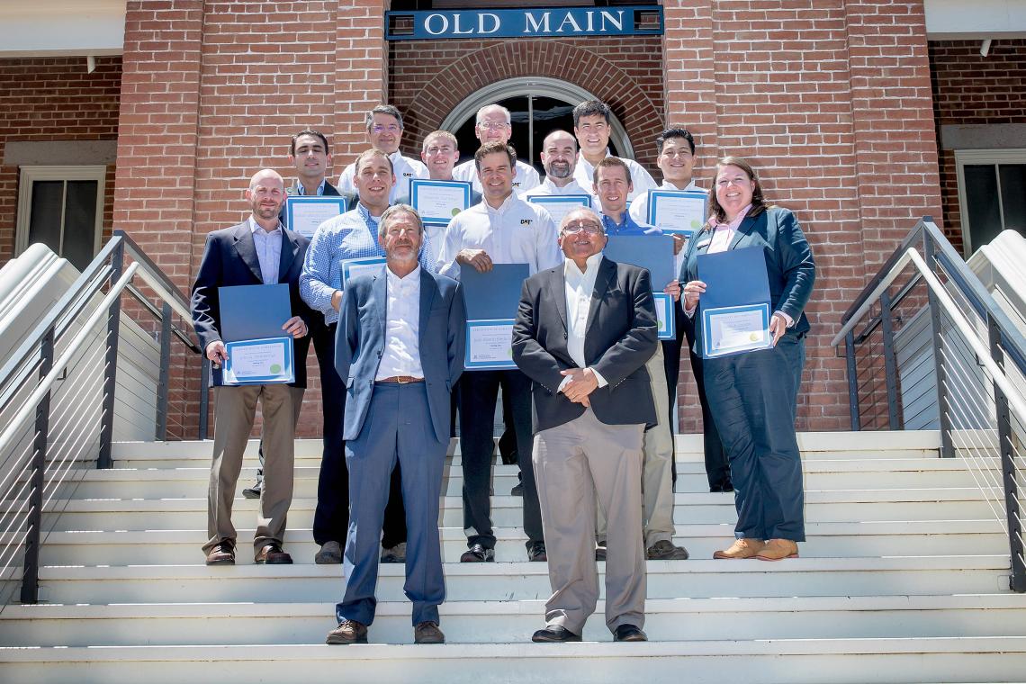 John Kemeny , chair of the UA Department of Mining and Geological Engineering, and Victor Tenorio , MGE professor of practice, with the inaugural class of 12 graduates of the Mining 360 Program. John Kemeny , chair of the UA Department of Mining and Geological Engineering, and Victor Tenorio , MGE professor of practice, with the inaugural class of 12 graduates of the Mining 360 Program.