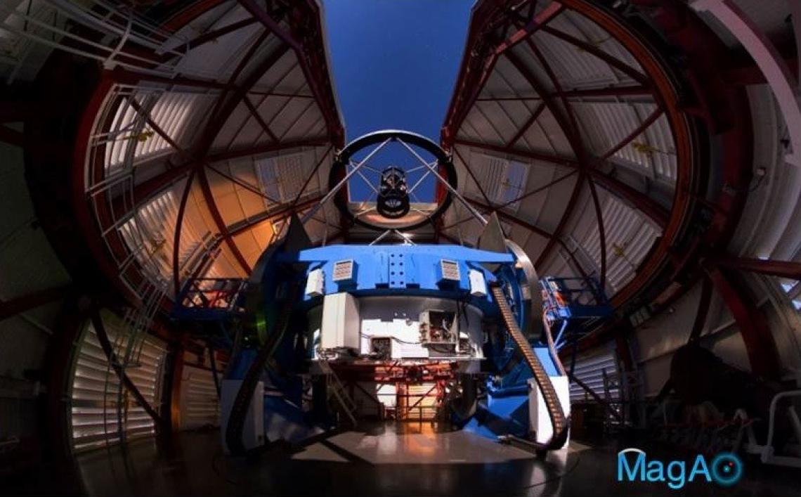 The Magellan Telescope with MagAO’s Adaptive Secondary Mirror jmounted at the top looking down some 30 feet onto the 21-foot diameter primary mirror, which is encased inside the blue mirror cell.