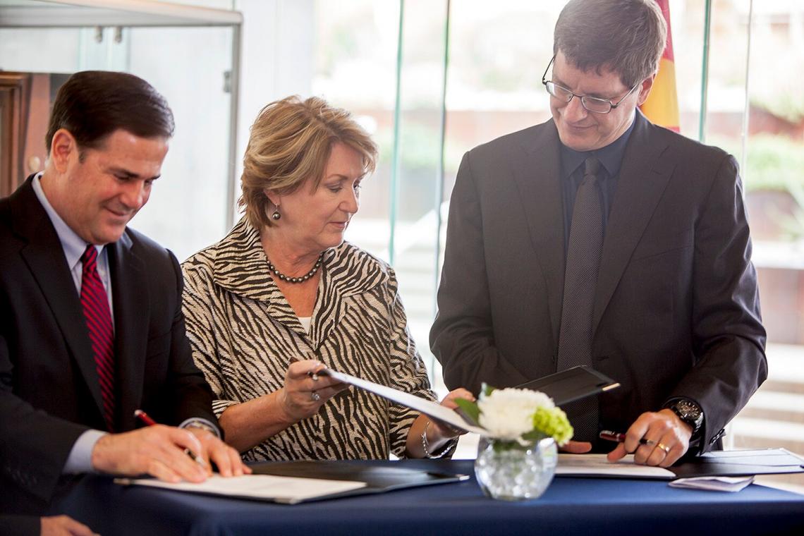 Arizona Gov. Doug Ducey , UA President Ann Weaver Hart and Uber executive Brian McClendon at Tuesday's news conference to announce a partnership between the UA and Uber. Arizona Gov. Doug Ducey , UA President Ann Weaver Hart and Uber executive Brian McClendon at Tuesday's news conference to announce a partnership between the UA and Uber.