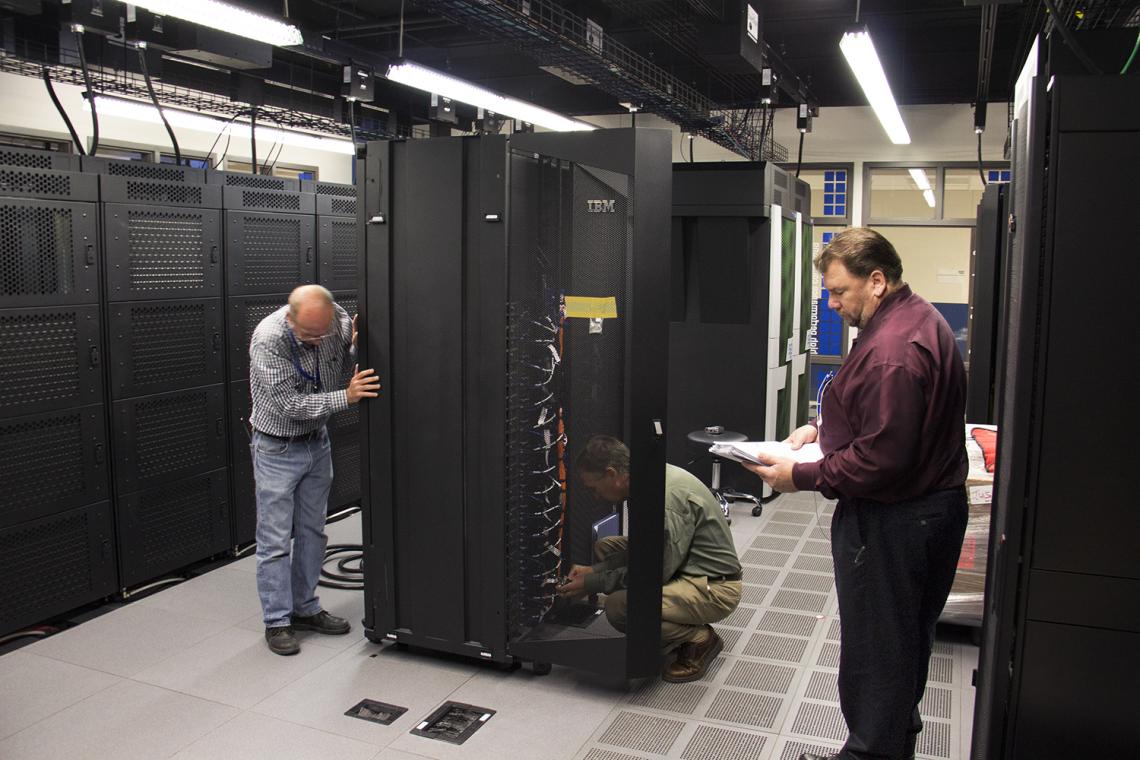 The supercomputer consists of many subunits housed in three refrigerator-sized cabinets.