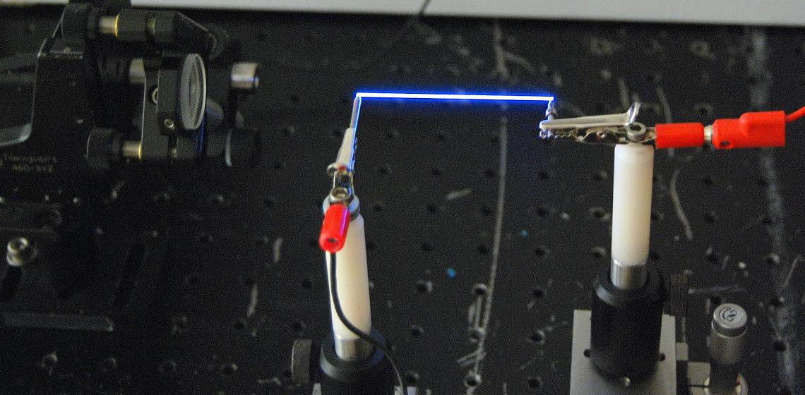 Miniature lightning: The team used a femtosecond laser to create a thin column of plasma – a special charged state of matter – in the air between two electrodes. Miniature lightning: The team used a femtosecond laser to create a thin column of plasma – a special charged state of matter – in the air between two electrodes.