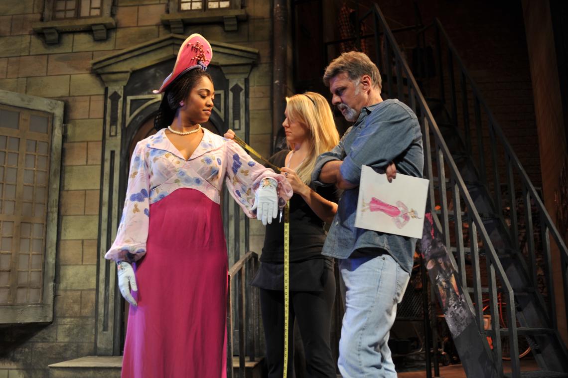 Besides the onstage actors, a number of other UA students, faculty and staff are involved in Arizona Repertory Theatre productions, working on set design, costumes, lighting and sound. Here, during a past production, Kelli Goodson measures UA musical thea