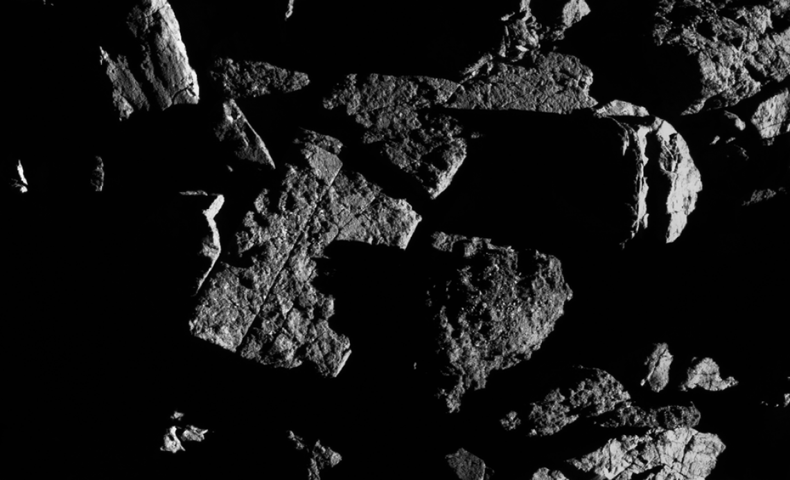 This image, taken by the spacecraft from a distance of 0.4 miles, shows a group of large boulders located just north of asteroid Bennu’s equatorial region, with two exhibiting linear cracks. For scale, the crack that runs through the rectangular boulder This image, taken by the spacecraft from a distance of 0.4 miles, shows a group of large boulders located just north of asteroid Bennu’s equatorial region, with two exhibiting linear cracks. For scale, the crack that runs through the rectangular boulder
