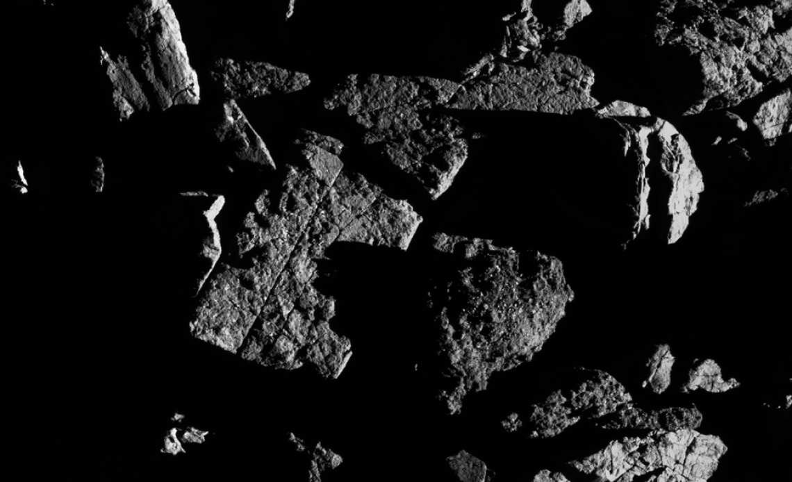 This image, taken by the spacecraft from a distance of 0.4 miles, shows a group of large boulders located just north of asteroid Bennu’s equatorial region, with two exhibiting linear cracks. For scale, the crack that runs through the rectangular boulder  