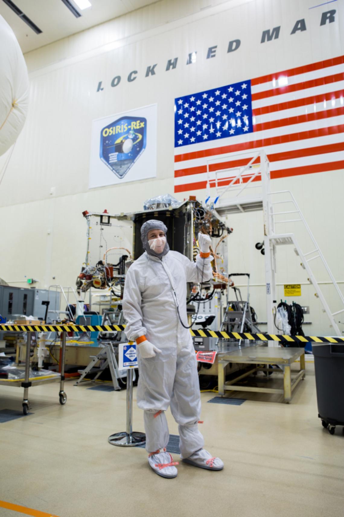 Systems engineer Bradley Williams with the OSIRIS-REx spacecraft in the Lockheed Martin cleanroom.
Systems engineer Bradley Williams with the OSIRIS-REx spacecraft in the Lockheed Martin cleanroom.