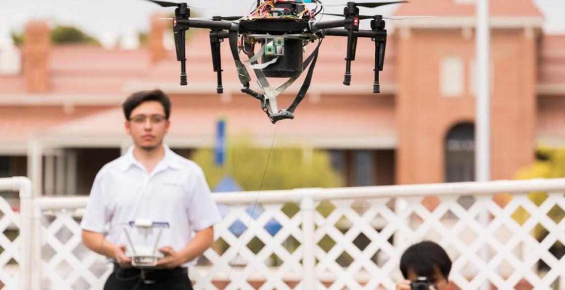 A student demonstrates his team’s drone-mounted pollen dispenser at Engineering Design Day. A student demonstrates his team’s drone-mounted pollen dispenser at Engineering Design Day.