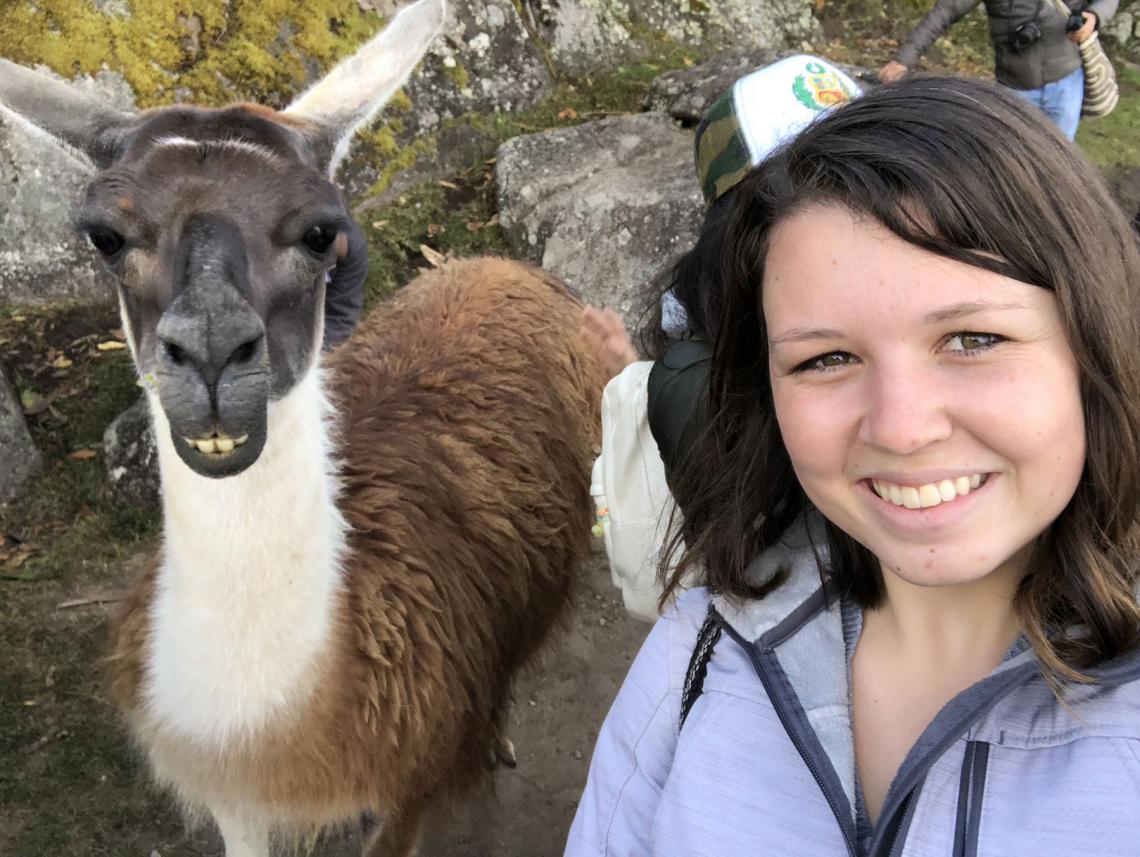 Gracie Krigbaum with a llama in Machu Picchu during a trip to Peru.