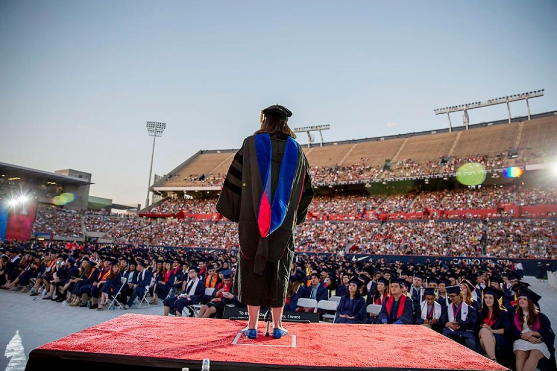 Professor Melissa Fitch addresses the crowd during the pre-Commencement show last year. Thousands of UA students will receive degrees during the 2017 ceremony, to be held in Arizona Stadium on May 12.  