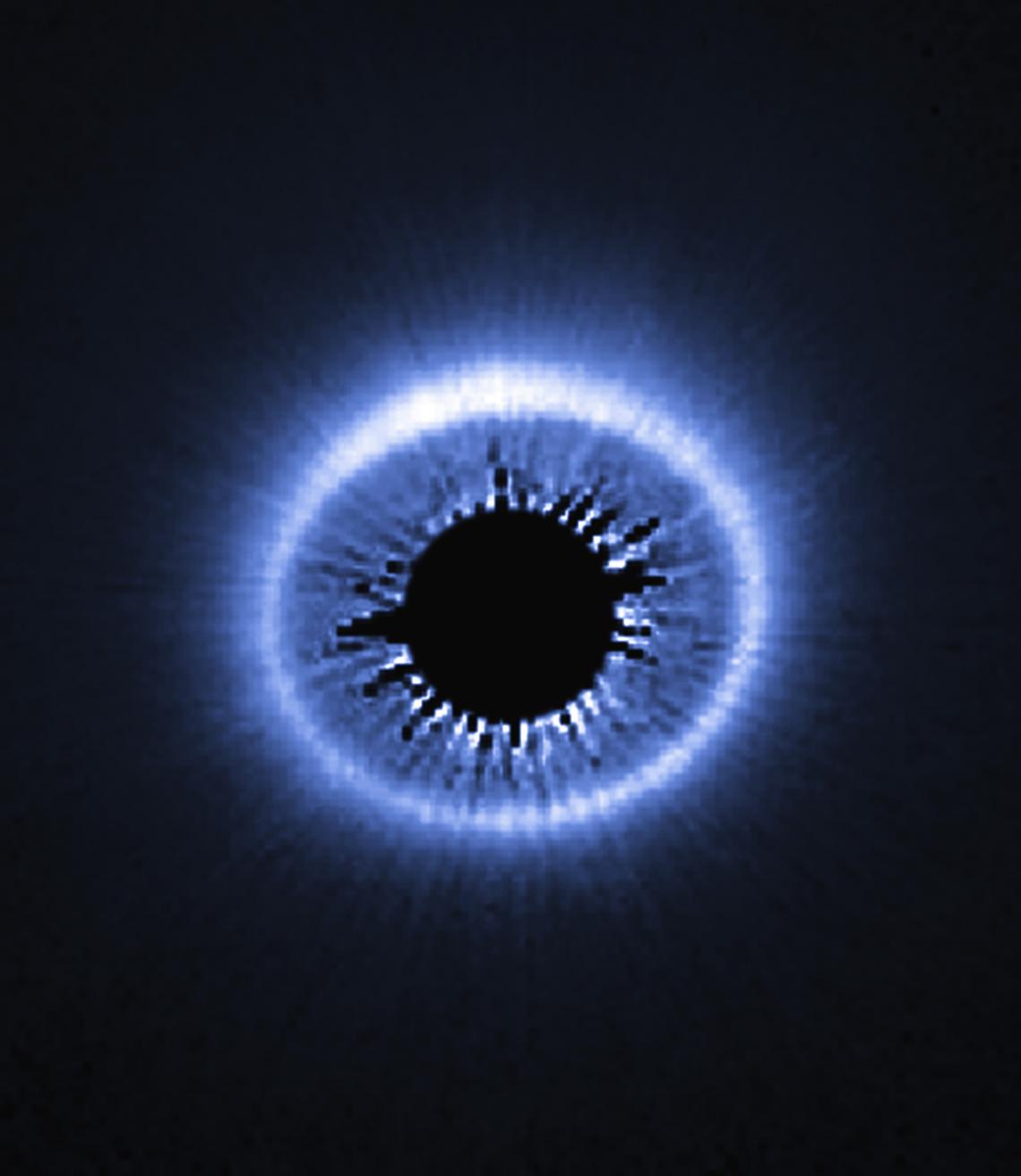 Located 169 light-years from Earth, circumstellar disk HD 181327 is seen nearly face-on. The image, taken with the Hubble Space Telescope, reveals a vast disk of dust and debris around the central star, whose light has been blocked out so that the very fa