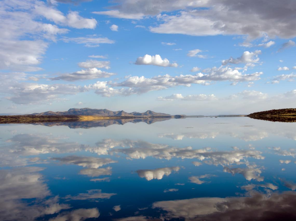 Lake Magadi, pictured during the wet season, periodically dries and floods in response to seasonal rains that cover the lakebed evaporites with up to 3 to 6 feet of water. Lake Magadi, pictured during the wet season, periodically dries and floods in response to seasonal rains that cover the lakebed evaporites with up to 3 to 6 feet of water.