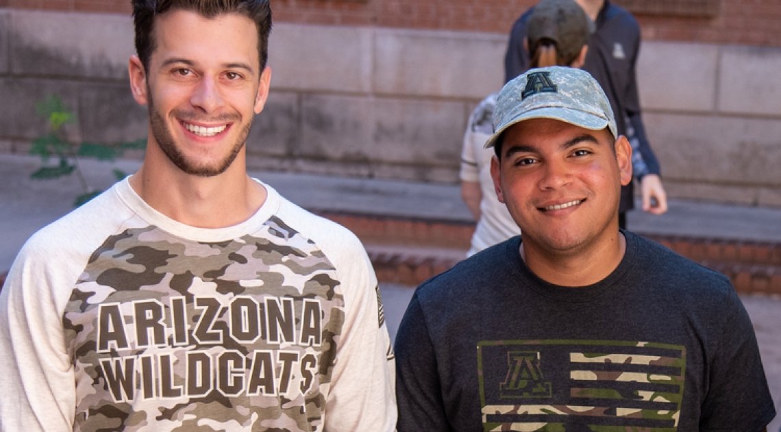 Student veterans John Krause and Manny Alberto Matias modeled Operation Hat Trick merchandise to support military service members and veterans.