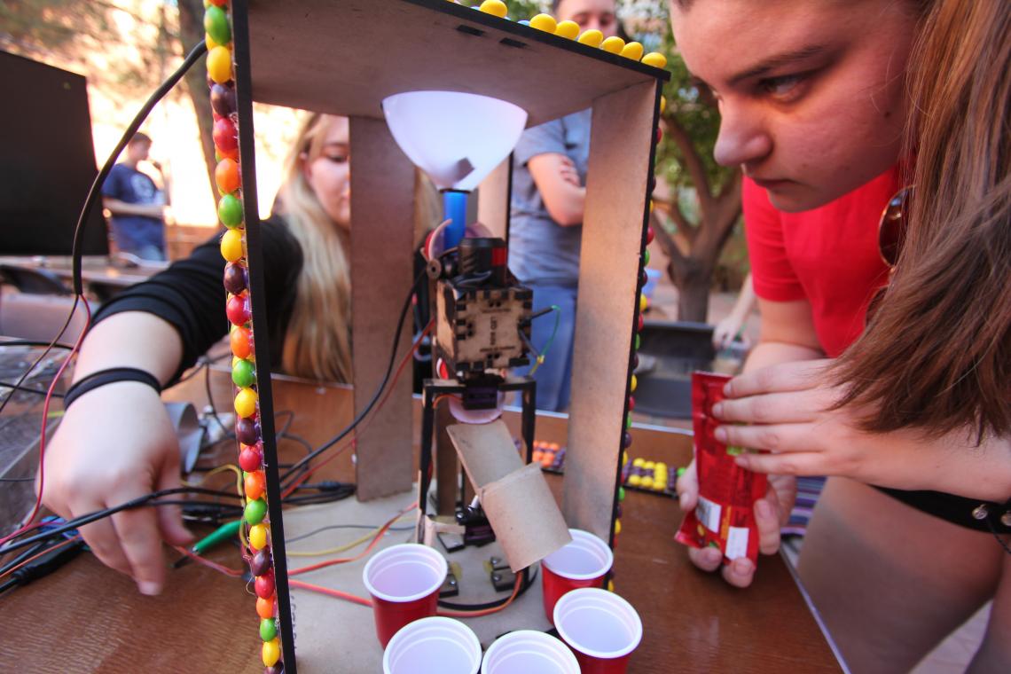 A team confirms all systems are go on its Skittle-sorting machine before the undergraduate design competition co-hosted by the UA Department of Biomedical Engineering and School of Information.