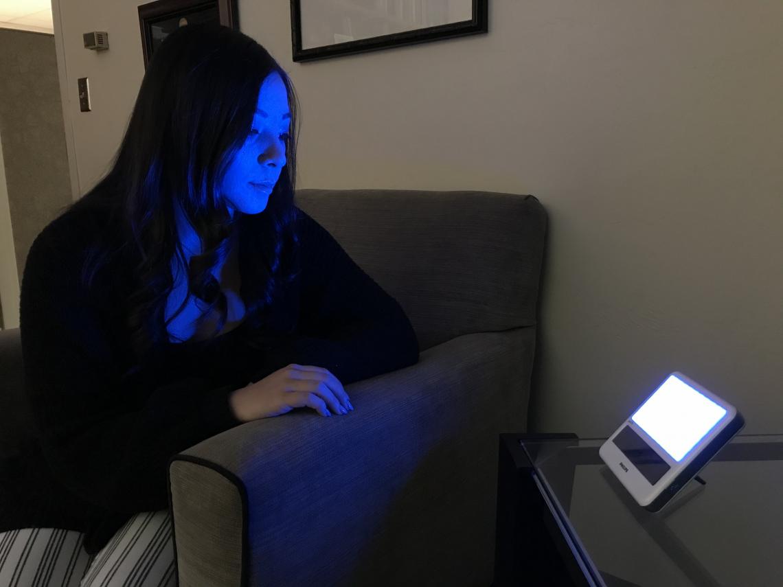 Research Technician Cami Barnes tests a blue light device. Research Technician Cami Barnes tests a blue light device.
