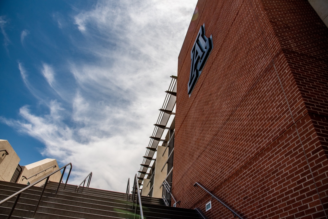 A staircase runs next to a tall brick wall with a block "A" on it.