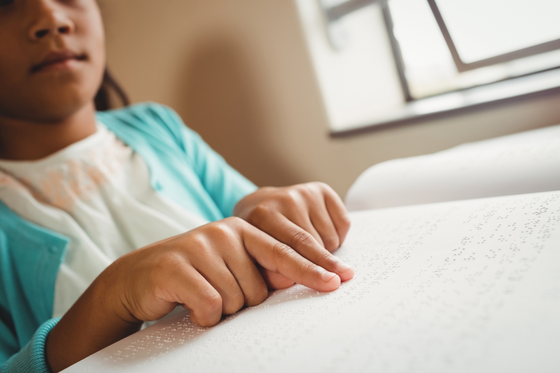 a child reading with Braille