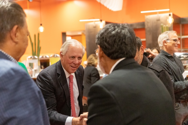 Robert C. Robbins shaking hands with another person