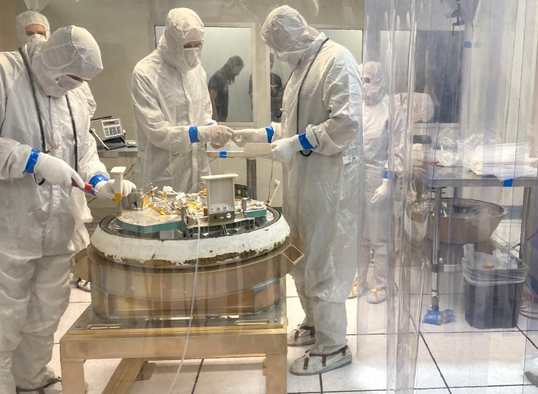 Clean room crew practicing disassembling the sample capsule after it has been recovered from its landing site. Clean room crew practicing disassembling the sample capsule after it has been recovered from its landing site.
