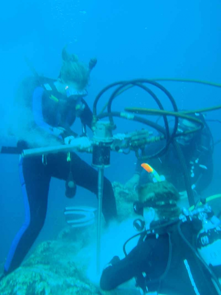 Drilling coral core samples underwater Thompson and her research team collecting core samples from a coral reef in Galapagos.