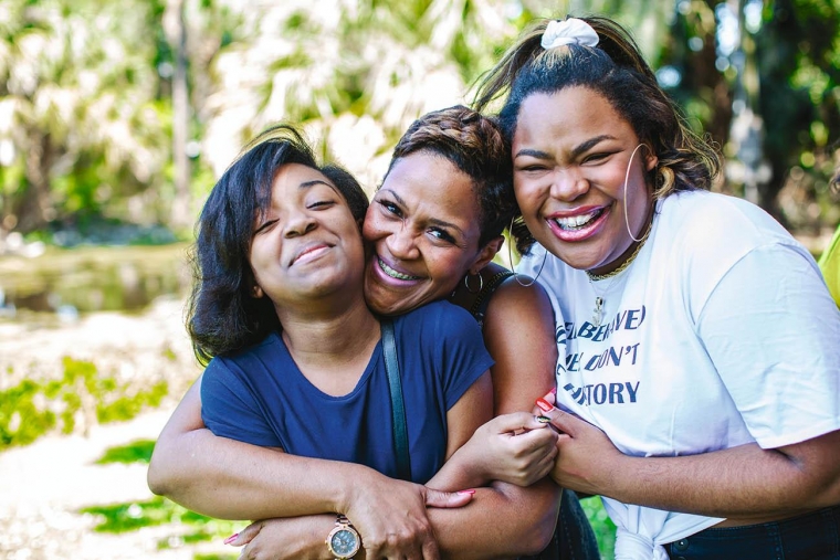 three people hugging
