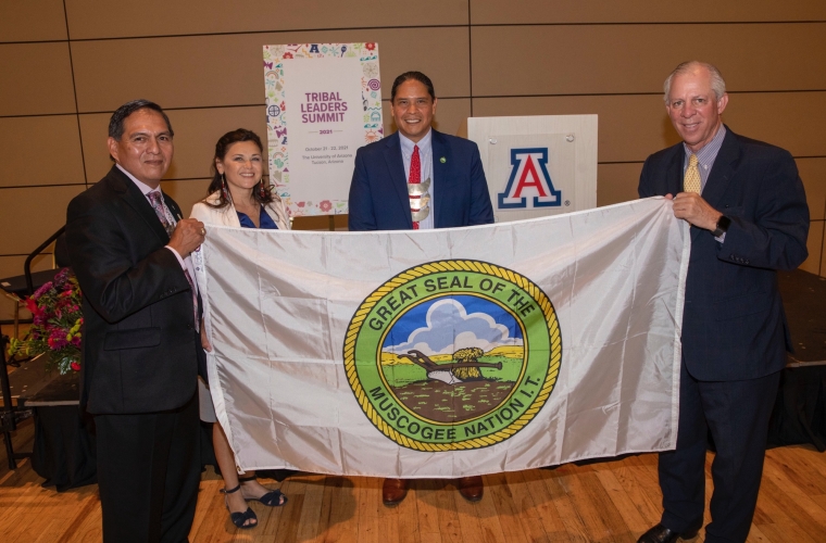 people posing for a photo with a flag