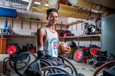 Josh Brewer in the UA Men's Wheelchair Basketball Team's equipment room at the Student Recreation Center.   