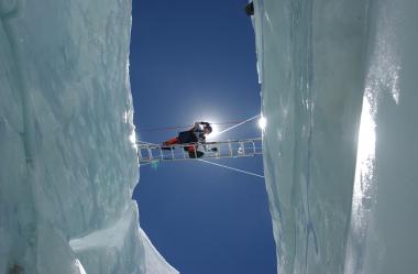 Levine crosses a crevasse in the Khumbu Icefall during an ascent up Mount Everest. 