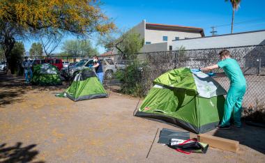 From left: University of Arizona medical students Christian Bergman, Erika Krall and Christopher Vance set up camping tents on the property of Z Mansion to serve as isolation units for homeless people suspected to have COVID-19. From left: University of Arizona medical students Christian Bergman, Erika Krall and Christopher Vance set up camping tents on the property of Z Mansion to serve as isolation units for homeless people suspected to have COVID-19.